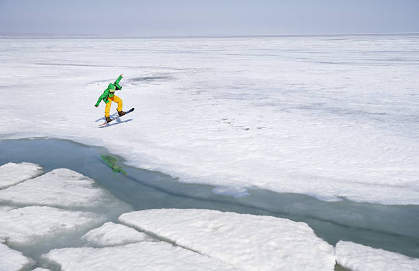 Snowboarding man outdoors in icy and snowy landscape