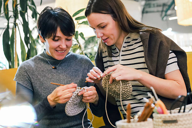 istock Two women crocheting together and enjoying a creative handmade project in a cozy workshop 2249278790