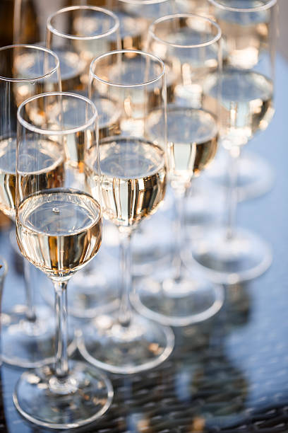 istock Glass goblets filled with sparkling champagne and stand on the table 2249281911