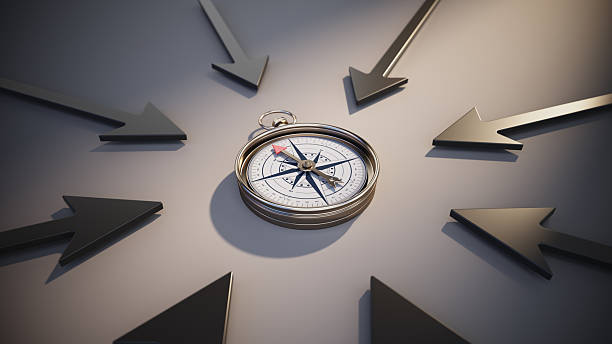 A compass lies at the center with arrows pointing in various directions. This setup symbolizes decision-making and the importance of guidance in choices.