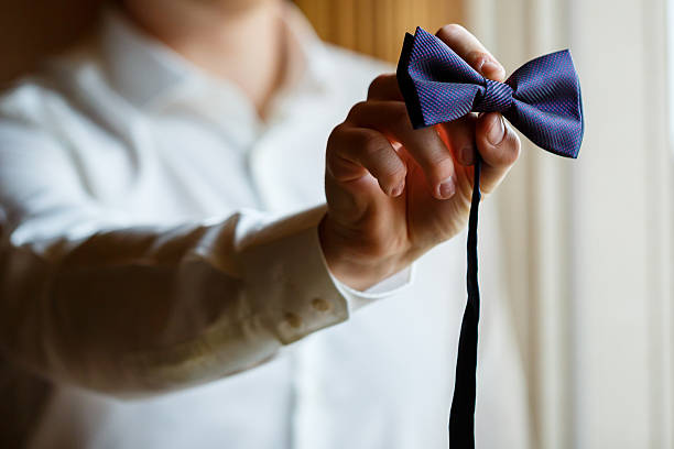 istock Man puts on a wedding suit and accessories on the wedding day. 2249283299