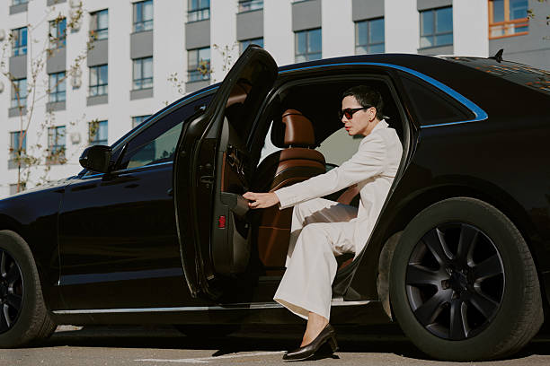 istock Middle Aged Woman Exiting Luxury Car in Urban Environment 2249283886