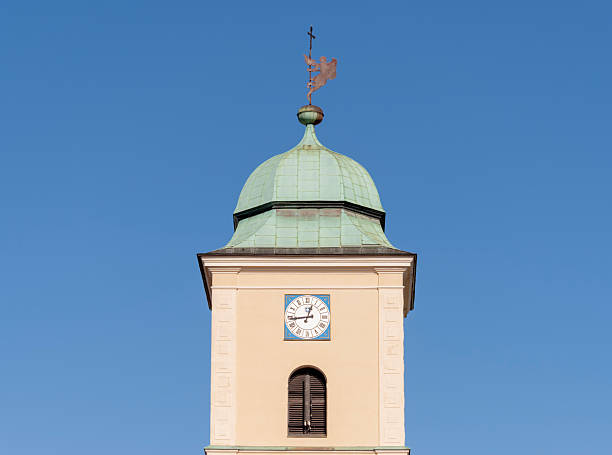 istock Historic clock tower with green dome roof against a clear blue sky 2249284807