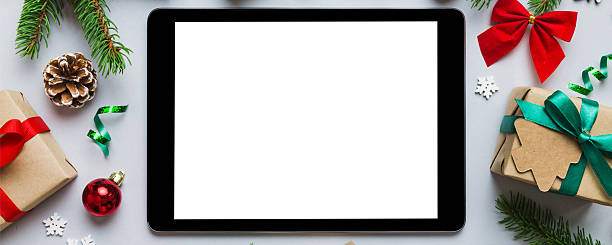 istock Digital tablet mock up with rustic Christmas decorations for app presentation top view with empty space for you design. Christmas online shopping concept. Tablet with copy space on colored background 2249284818