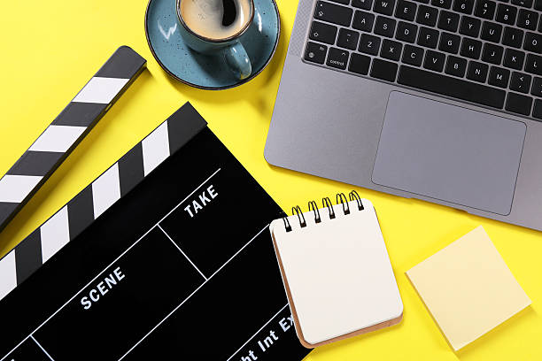 istock Flat lay composition with movie clapper on yellow background 2249285145