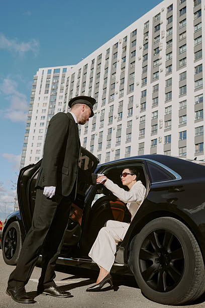 istock Chauffeur Assisting Middle Aged Woman Exiting Luxury Car 2249285282