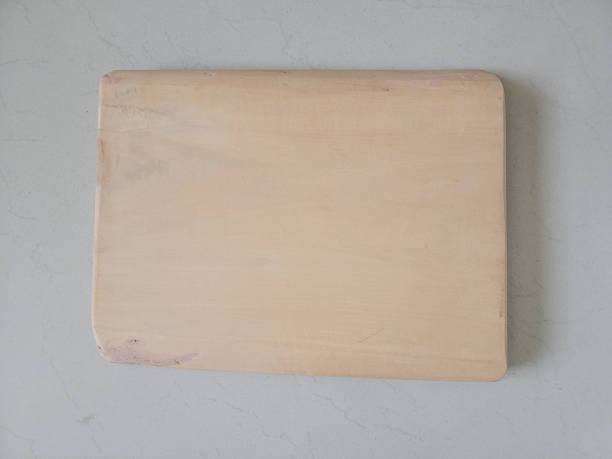 istock Wooden cutting board isolated on white background, plank wood in the kitchen 2249285973