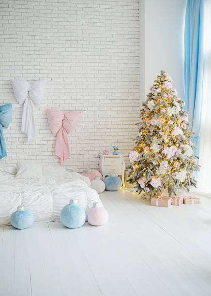 istock Festive bedroom with Christmas tree and decorative bows, winter holiday interior 2249287496