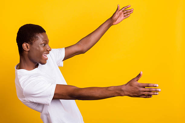 istock Profile side photo of afro american young man look empty space hold hands open isolated on yellow color background 2249287765
