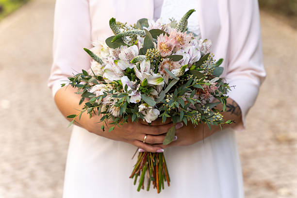 Bride Holding Elegant Wedding Bouquet With Soft Pastel Flowers For Romantic Celebration Themes
