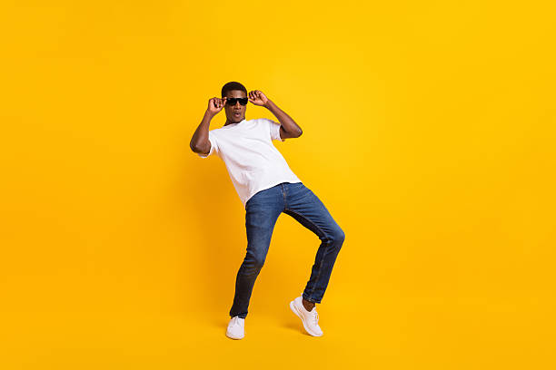 istock Full length body size view of attractive funky guy dancing having fun touching specs isolated over bright yellow color background 2249288004