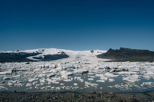A stunning view of Vatnajokull Glacier in Iceland with floating icebergs under a clear blue sky.