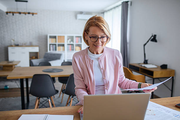 istock Woman Analyzing Home Budget on Laptop 2249288906