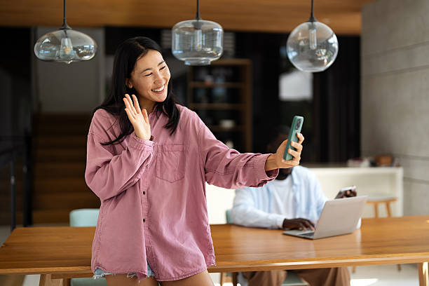 istock A happy smiling Asian woman using digital device, mobile phone for video call, selfie and fun 2249289004