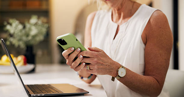 istock Hands, woman and typing with phone in home for editor feedback, remote work and submission schedule. Freelance journalist, mature person and tech in apartment to email source and reading online news 2249290496