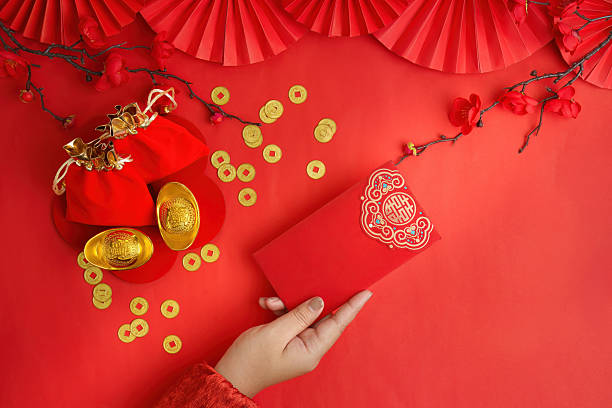 istock Lunar New Year celebration with red envelope and gold ingots on red background 2249290694