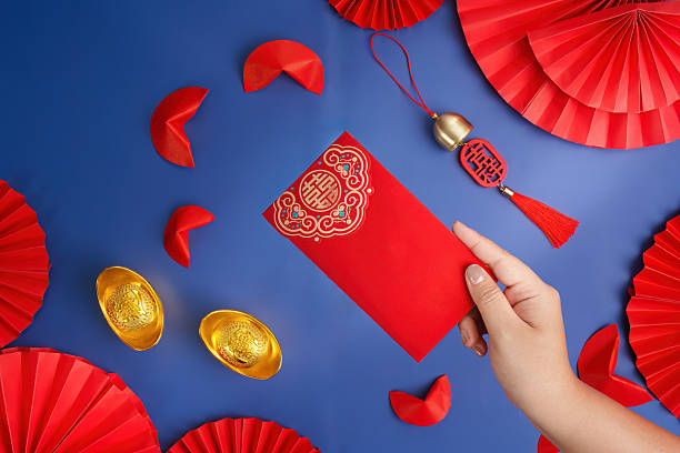 istock Lunar New Year red envelope and gold ingots on blue background 2249290777