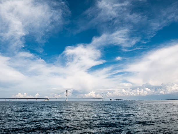 Aerial view of the Farø Bridges on a cloudy evening just before sunset in the southeastern part of Denmark. The Farø Bridges (Danish: Farøbroerne) are two road bridges that crosses Storstrømmen Sound and connects the islands of Falster and Zealand by highway