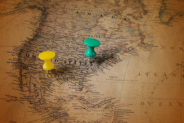 istock The color pins on old map,point on location. 2249291247