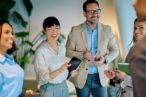 istock Diverse business team smiling and collaborating in an informal office discussion, sharing ideas and building connection 2249291851