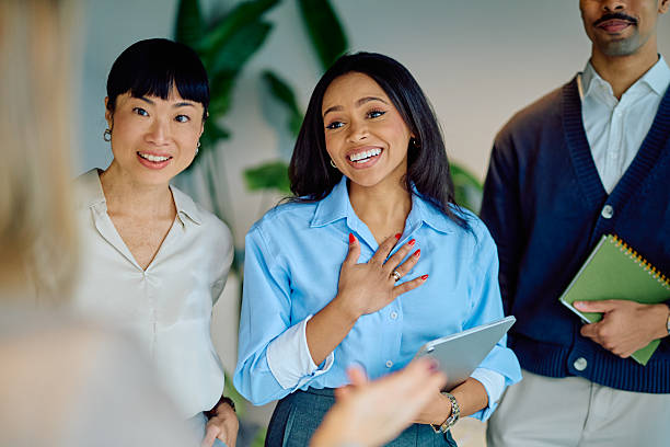 istock Diverse business team listening and smiling during office collaboration, engaging in conversation 2249292046