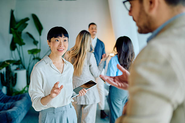 istock Enthusiastic multicultural business team collaborating and discussing ideas inside a modern office workspace 2249292886