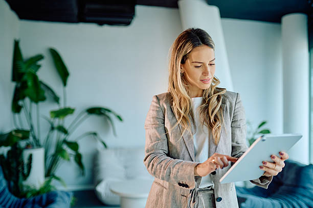 istock Businesswoman using digital tablet in modern office, managing tasks, connecting to online entrepreneurship and remote work 2249293315
