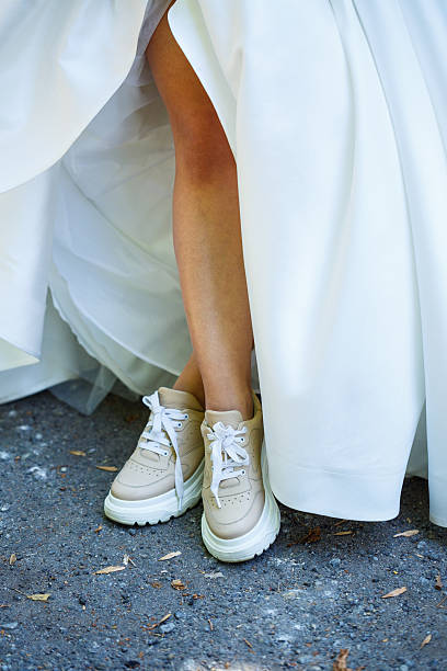 istock Bride in a white dress and sneakers on a wedding day 2249293529