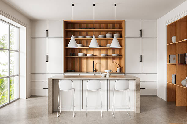istock Modern minimalist kitchen interior with white cabinets, wood accents, and pendant lighting in a bright, natural setting. 3D Rendering 2249293542