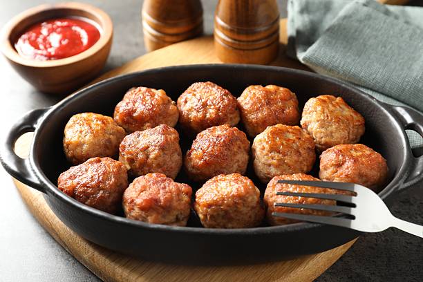 istock Tasty meatballs in baking dish served on grey table, closeup 2249296774