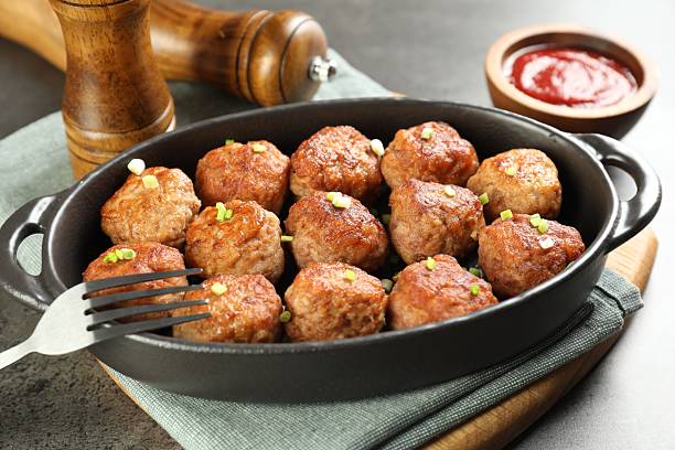 istock Tasty meatballs in baking dish served on grey table, closeup 2249296792