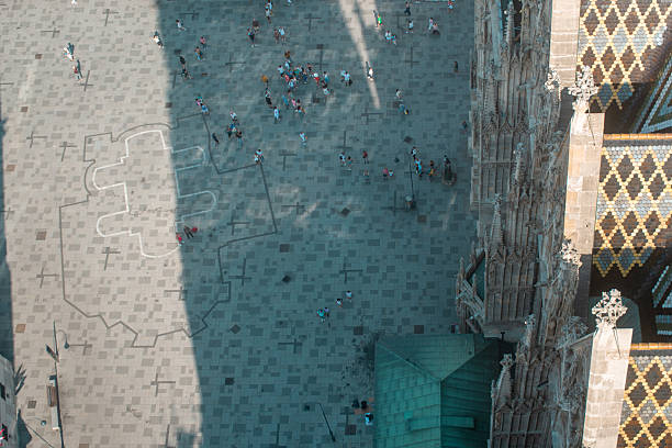 A dynamic aerial perspective captures crowds of people moving through Vienna’s bustling walkways. The scene highlights the rhythm of daily life as pedestrians weave between shops, cafés, and historic architecture, capturing the lively atmosphere of the city on foot.