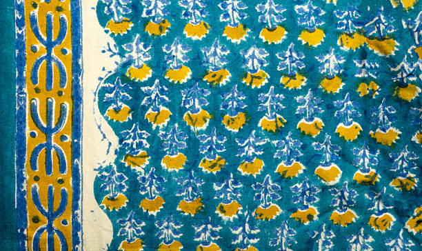Vibrant turquoise hand block-printed Indian cotton textile with mustard-yellow floral butis, light blue accents, and a golden-yellow geometric border. Classic Sanganeri or Bagru style with traditional charm.