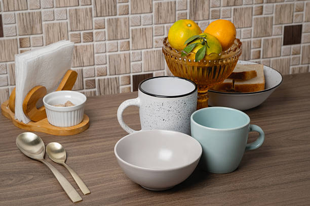 istock Beautifully arranged breakfast items on a wooden table with fruit and tableware at a cozy kitchen 2249299075