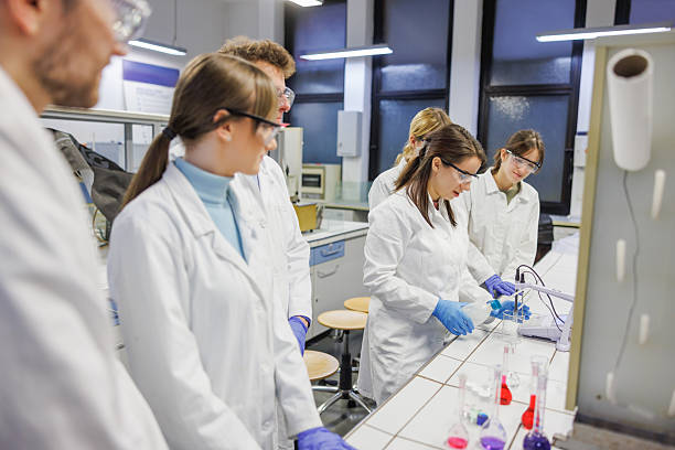 istock Young female scientist wearing protective workwear and using lab equipment, group research in the lab 2249299310