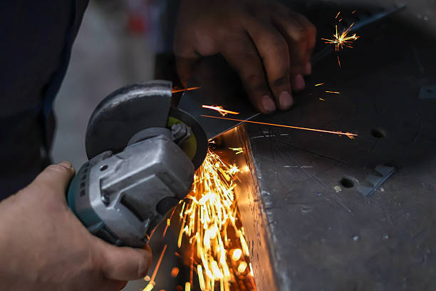 istock Close-up of a worker's hands using an angle grinder to cut metal 2249299314
