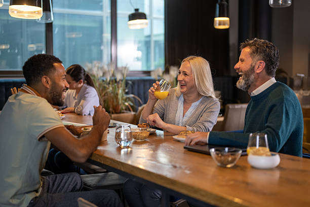 istock Diverse Business Executives Enjoying Drinks and Lively Conversation in Modern Office Bar 2249300686