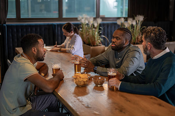 istock Diverse Business Professionals Enjoying Drinks and Conversation in Modern Office Bar 2249300711