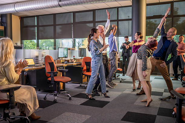 istock Diverse Team Celebrating Success with Cheerful Office Huddle in Modern Workspace 2249301069