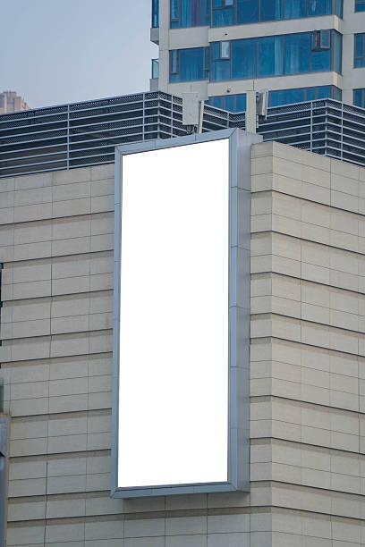 istock A mockup of a blank white billboard framed by a modern building facade, ideal for advertising 2249302266