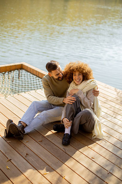 istock Couple enjoying a sunny day by the lakeside, sharing laughter and affection 2249302455