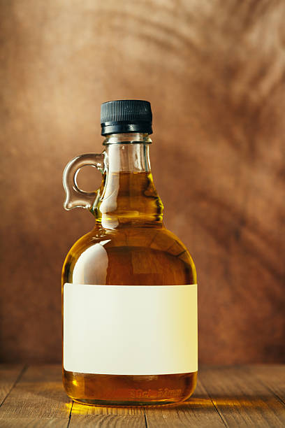Unopened, blank-label olive oil bottle on a wooden table
