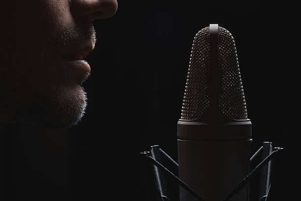 istock Studio close-up. Voice test into grid mic. Mood light, dark art. Sound, talk, rec cue. 2249302767