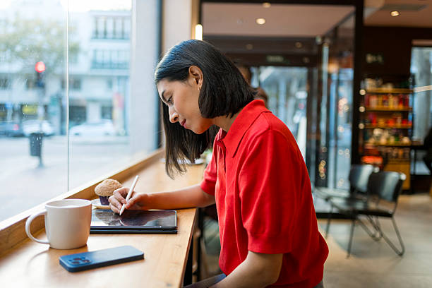 istock Woman working on digital tablet in a cafe 2249302773