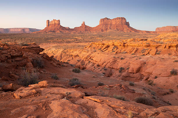 istock Dramatic view of the Monument Valley's magnificent butte and mittens lit up during a sunset.Iconic butte, spire and mitten formations used as a backdrop in many old western movies. Navajo,Arizona. 2249303377