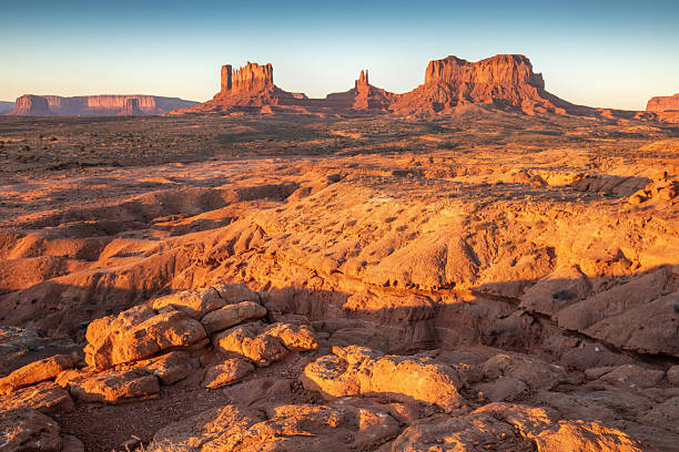 istock Dramatic view of the Monument Valley's magnificent butte and mittens lit up during a sunset.Iconic butte, spire and mitten formations used as a backdrop in many old western movies. Navajo,Arizona. 2249303593