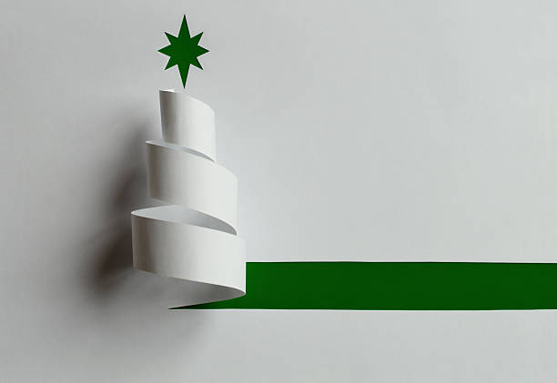 istock Minimalist paper Christmas tree with green star on white background 2249303980