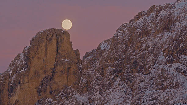 istock Panoramic view of Dolomite mountain peaks under a glowing full moon. 2249304176