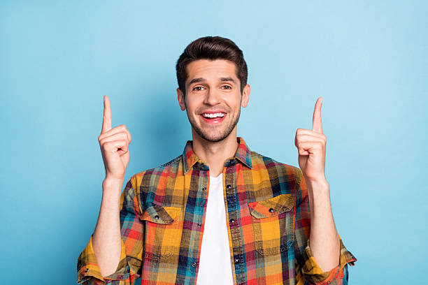 istock Portrait of attractive cheerful guy pointing forefingers up copy empty space isolated over bright blue color background 2249305936
