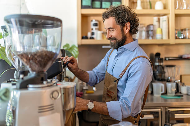 istock Stylish Barista Preparing Fresh Ground Coffee at Counter 2249305970